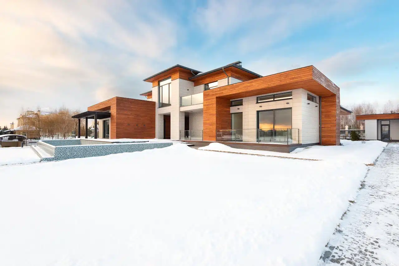 New cottage house facade and snowy yard